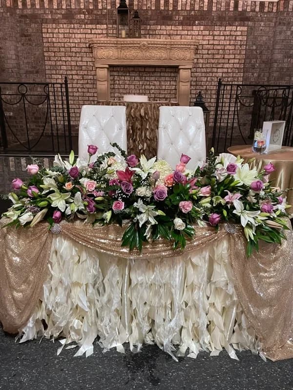 Purple floral fireplace wedding decorations for fall ceremony at La Hacienda Event Venue