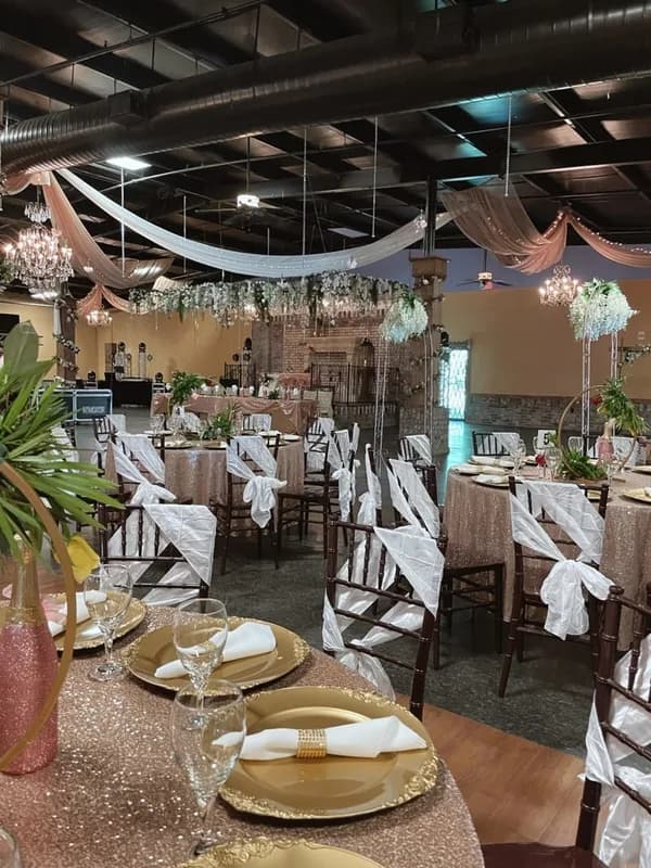 Rose gold chandeliers and elegant wedding reception lighting at La Hacienda Event Venue