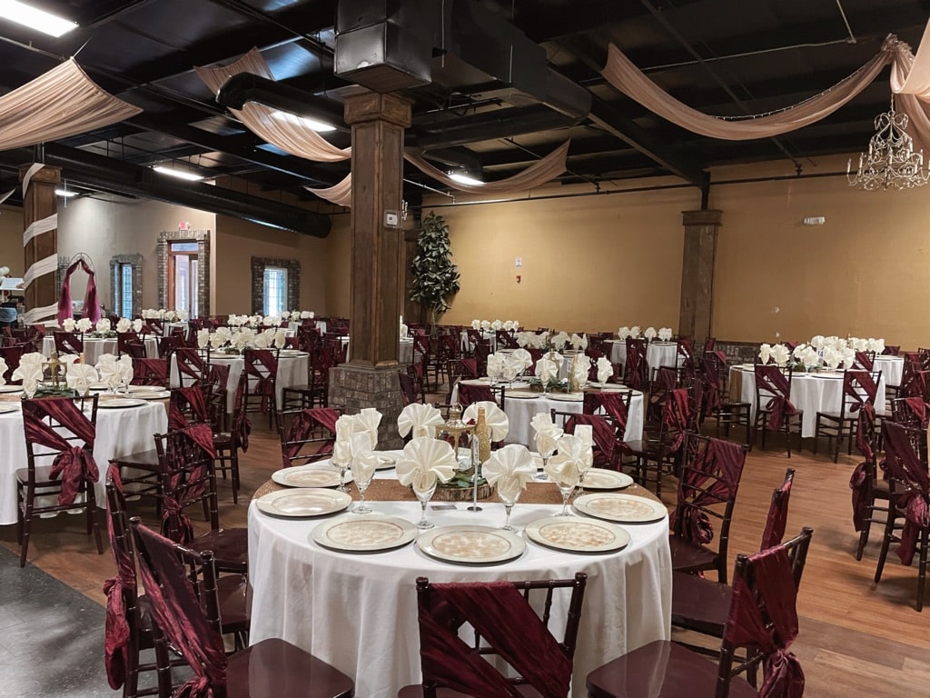 Event Venue Gainesville GA Quinceañera table setup with red accents and white linens at La Hacienda event venue Gainesville GA